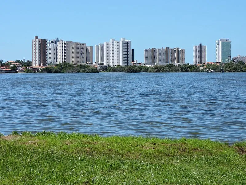 Vista da Lagoa da Jansen com gramado à frente e prédios ao fundo em São Luís