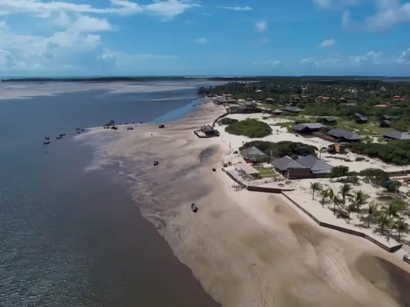 Vista aérea de Atins, no Maranhão, com praia, barcos e vilas próximas aos Lençóis Maranhenses.
